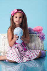 Wall Mural - cute little girl on blue background