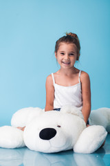 Wall Mural - cute little girl on blue background