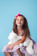 Wall Mural - cute little girl on blue background