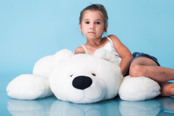Wall Mural - cute little girl on blue background