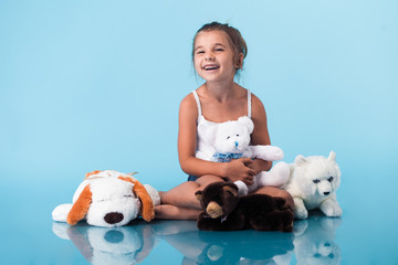 Wall Mural - cute little girl on blue background