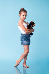 Wall Mural - cute little girl on blue background