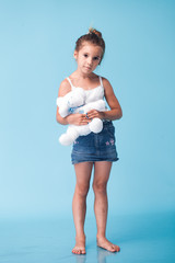 Wall Mural - cute little girl on blue background