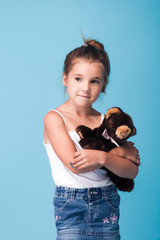 Wall Mural - cute little girl on blue background
