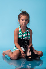 Wall Mural - little girl wearing big mothers shoes