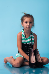 Wall Mural - little girl wearing big mothers shoes