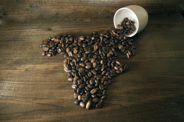 coffee beans are laid out in the shape of Africa against the bac