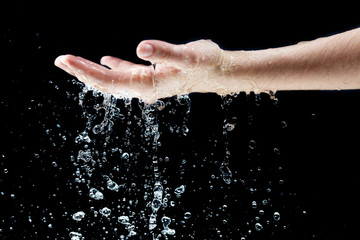 Wall Mural - Water falling on hand