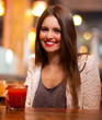 Young woman drinking in a bar