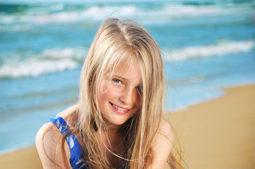 Wall Mural - Portrait of little girl on a sandy beach