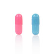 Blue and pink medical capsule on white, clipping path included