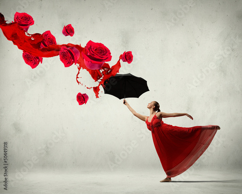 Fototapeta na wymiar Ballet dancer in flying satin dress with umbrella