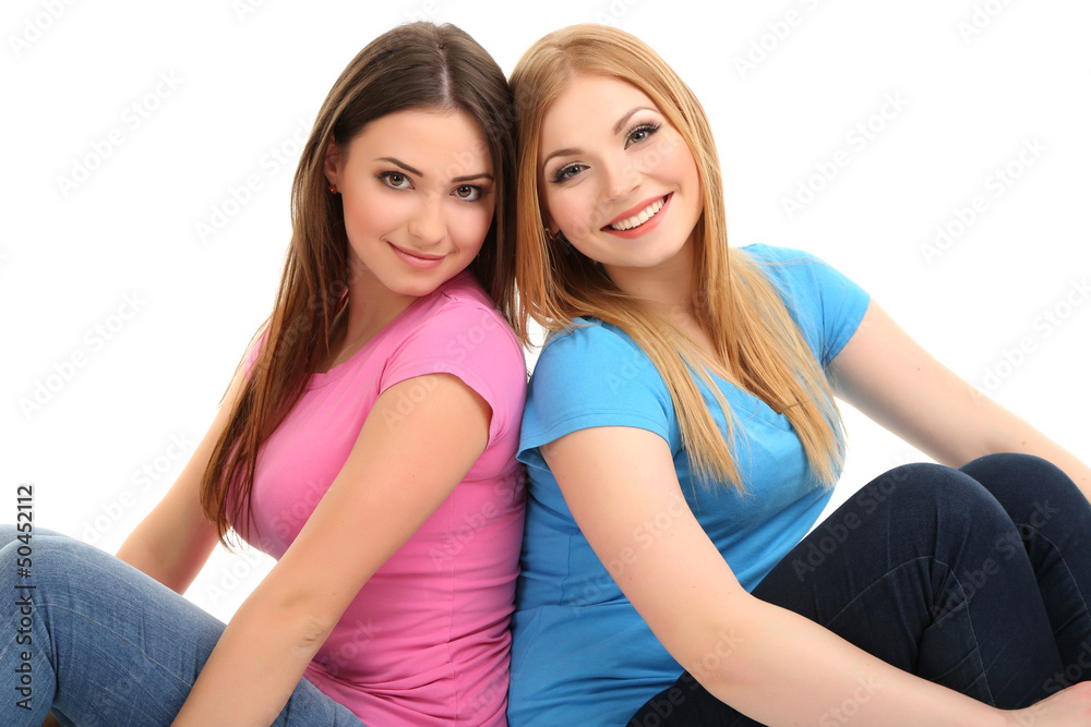 Two girl friends smiling isolated on white