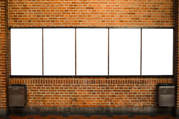 Five empty billboards on brick wall