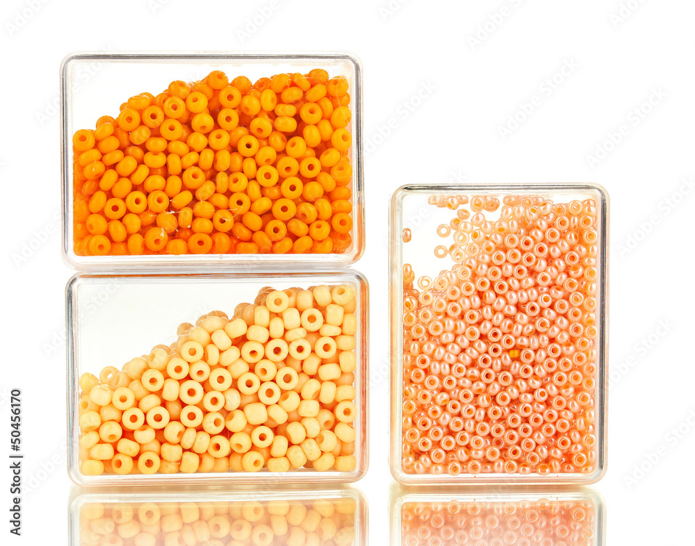 Colorful beads heap in boxes isolated on white