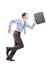 Canvas Print - Full length portrait of a businessman running with a briefcase