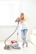 © Anton Maltsev - Attractive girl with vacuum cleaner