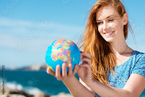 Junge frau mit globus am meer Poster Mural XXL