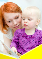 Mother and her daughter reading a book