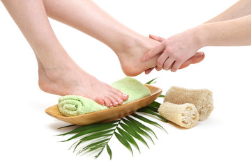 Canvas Print - Female feet receiving a massage, isolated on white