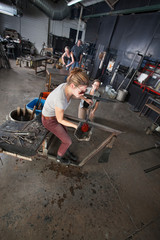 Worker Holding Red Hot Glass