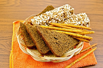 Poster - Rye bread and crispbreads in a wicker plate on napkin