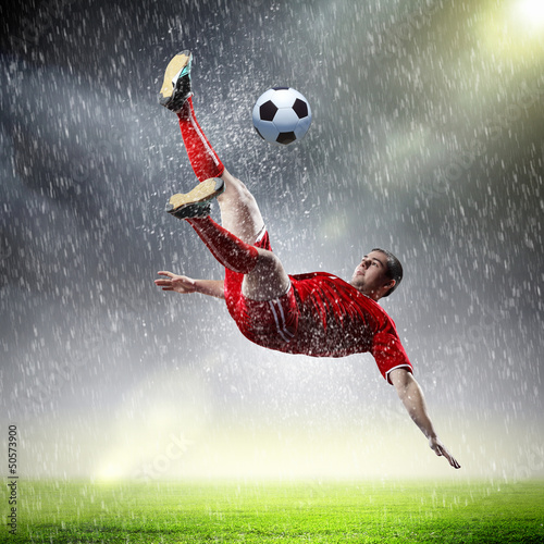 Plakat na zamówienie football player striking the ball