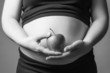 Pregnant woman holding a red apple in her hands