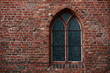 Gothic brick wall with a window,a stained glass window