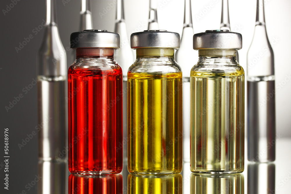 medical ampules on grey background