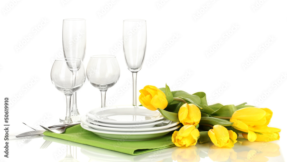 Yellow tulips and utensils for serving isolated on white