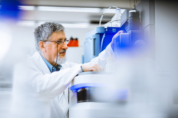 senior male researcher carrying out scientific research in a lab