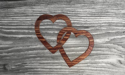 Cute two hearts symbol in a wooden background