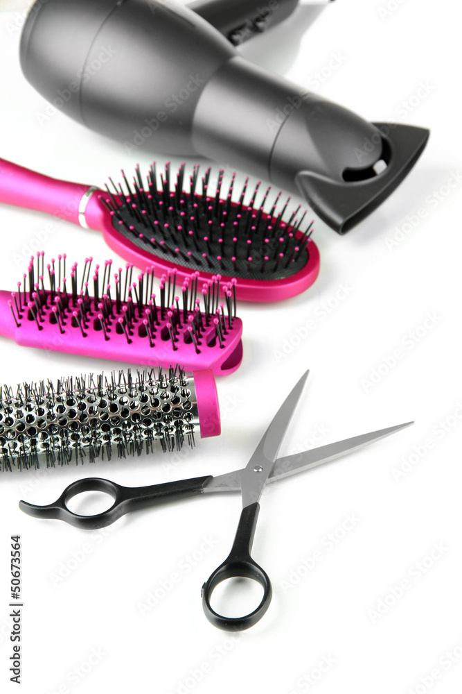 Comb brushes, hairdryer and cutting shears, isolated on white