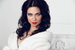 © Victoria Andreas - Beautiful Brunette Girl in fur coat over modern interior white b