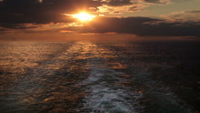 Sunset And Wake Of A Ship