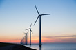 © Kruwt - Long row of windturbines with sunset over the sea