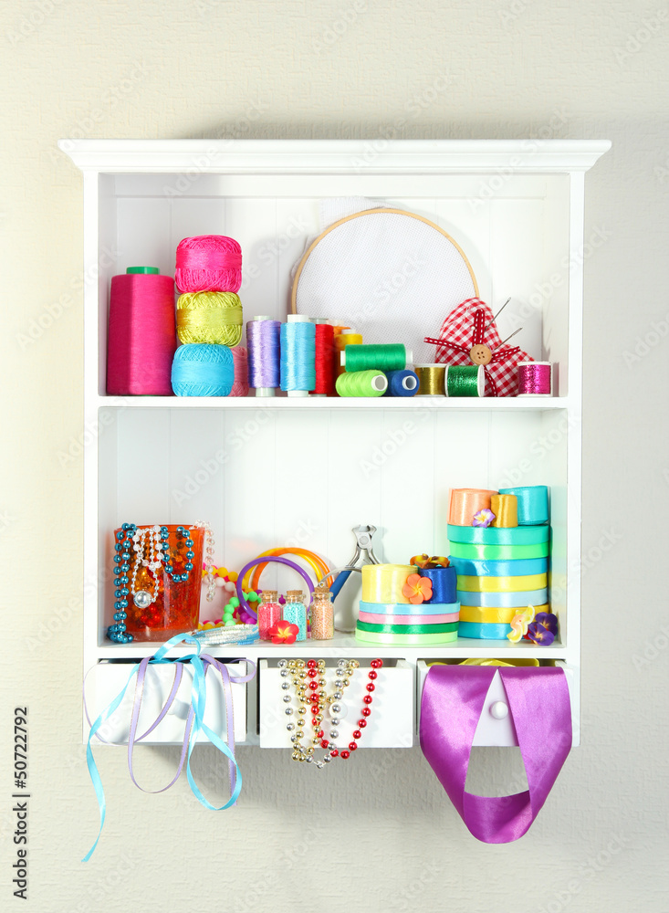 Beautiful white shelves with thread and material for