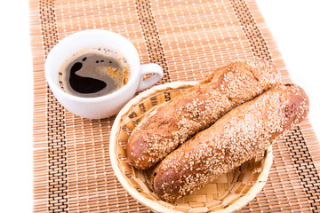 Wall Mural - Freshly baked bread rolls with sesame with cup of coffee