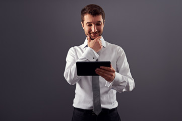 Canvas Print - businessman looking at tablet pc and smiling