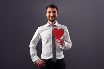 Canvas Print - man holding red heart and smiling