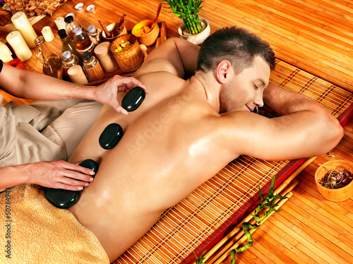 Nowoczesny obraz na płótnie Man getting stone therapy massage .