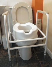 Disabled Toilet With Frame Handles And Raised Seat