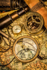 vintage magnifying glass lies on an ancient world map