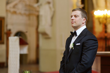 Wall Mural - Groom waiting for the bride in church