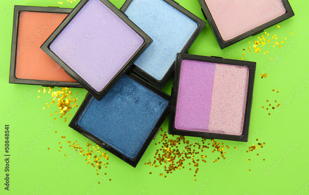 Beautiful bright eye shadows on green background