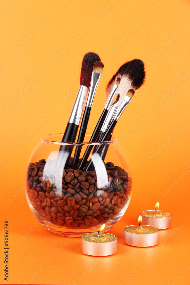 Glass bowl with coffee beans,brushes and candles