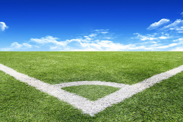 Football and soccer field grass stadium Blue sky background