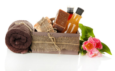 Composition of cosmetic bottles and soap in crate, isolated