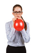 Girl with glasses inflating a red ball